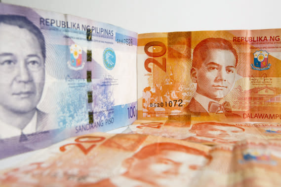 Manuel A. Roxas, left, and Manuel L. Quezon, former presidents of the Philippines, are displayed on a one hundred, left, and twenty peso banknotes respectively. (Photo: Getty Images)
