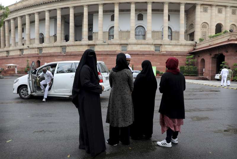 印度下議院上星期通過法案，禁止說3次「休妻」離婚的穆斯林習俗，一些穆斯林婦女站在新德里的國會外等待投票結果（美聯社）
