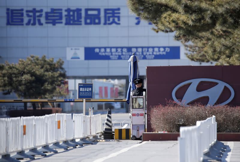 FILE PHOTO: A security guard is seen at the main entrance of a plant of Hyundai Motor Co on the outskirts of Beijing