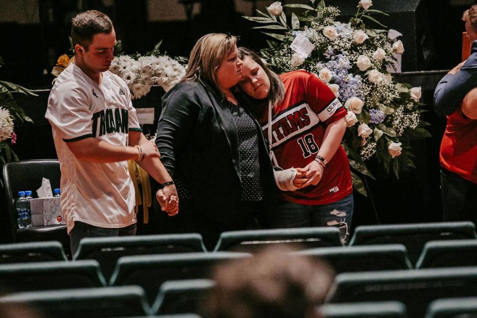 At Mia Stokes’ funeral on Feb. 14, 2020, brother Matt Stokes (left), mother Holly Stokes (center) and twin sister Mallory consoled each other.
