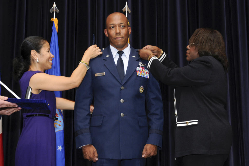 In this image provided by the U.S. Air Force, Air Force Chief of Staff Gen. CQ Brown Jr.'s wife, Sharene Brown, left, and mother, Kay Brown, right, pin on Brown's first star during his promotion to brigadier general on Sept. 18, 2009, at Aviano Air Base, Italy. President Joe Biden is expected to announce Air Force Gen. CQ Brown Jr., a history-making fighter pilot with recent experience countering China in the Pacific, to serve as the next chairman of the Joint Chiefs of Staff. If confirmed by the Senate, Brown would replace the current chairman of the Joint Chiefs of Staff, Army Gen. Mark Milley, whose term ends in October. (Staff Sgt. Patrick Dixon/U.S. Air Force)