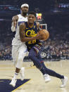 Cleveland Cavaliers' Alfonzo McKinnie (28) drives past Orlando Magic's Terrence Ross (8) in the first half of an NBA basketball game, Friday, Dec. 6, 2019, in Cleveland. (AP Photo/Tony Dejak)