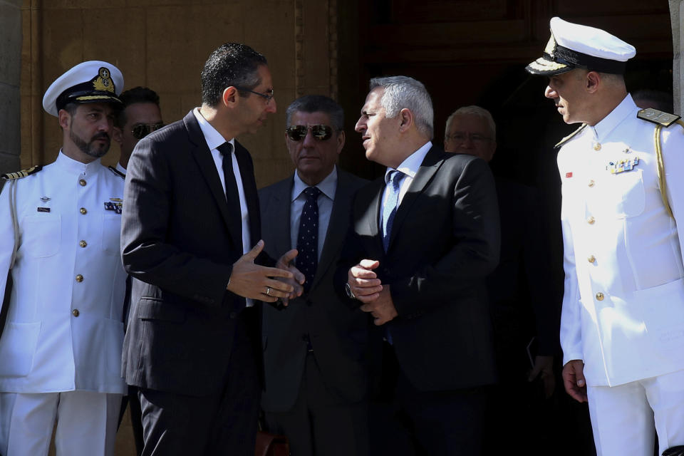 Cyprus' defense Minister Savvas Angelides, second left, talks with his Greek counterpart Evaggelos Apostolakis after their meeting with Cyprus' president Nicos Anastasiades at the presidential palace in Nicosia, Cyprus, Wednesday, May 8, 2019. Cyprus says it will rally support from fellow European Union countries and others to counter Turkey's bid to drill in waters where the east Mediterranean island nation has exclusive economic rights. (AP Photo/Philipps Christou)