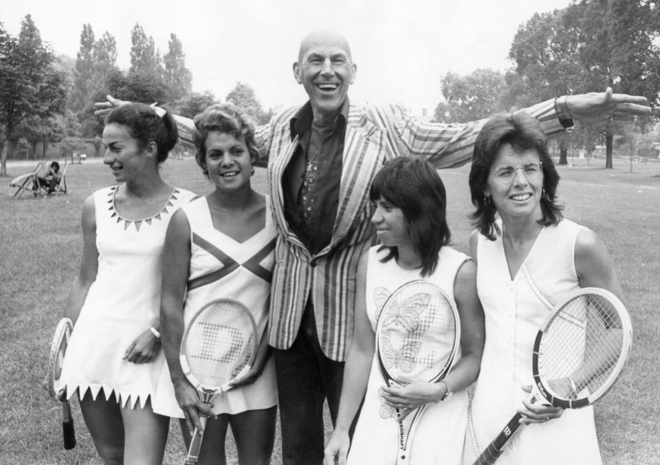 FILE - Ted Tinling, designer of women's tennis wear, is photographed with international tennis players wearing fashions designed for them for the 1973 Wimbledon Championships, posed in Kensington Gardens, London, June 22, 1973. From left are: Virginia Wade of Britain; Evonne Goolagong of Australia; Rosemary Casals of San Francisco; and Billie Jean King of Long Beach, Calif. Wednesday marks the 50th anniversary of the meeting on June 21, 1973, at the Gloucester Hotel — about a mile south of Hyde Park in the heart of the British capital — where King and nearly 60 other players agreed to form what today is known as the Women’s Tennis Association or WTA. (AP Photo/Robert Rider-Rider, File)