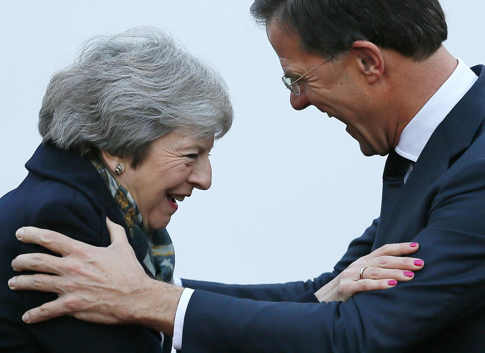 British Prime Minister Theresa May is greeted by Dutch Prime Minister Mark Rutte upon her arrival in The Hague, Netherlands, Tuesday, Dec. 11, 2018. Facing almost certain defeat, Prime Minister May on Monday postponed a vote in Parliament on her Brexit deal, saying she would go back to European Union leaders to seek changes to the divorce agreement. (AP Photo/Peter Dejong)