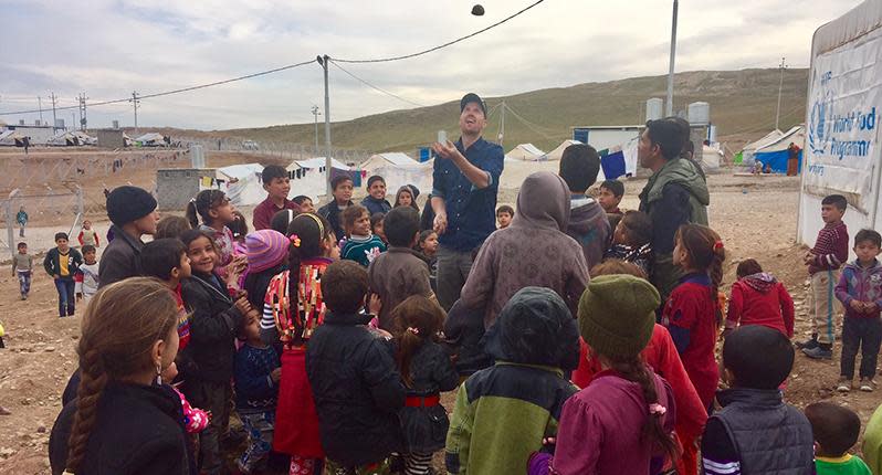 Producer Paul Waterhouse attempting some juggling in a camp south of Mosul