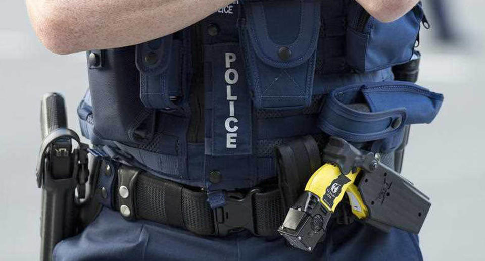 Stock photograph of a Queensland Police Officer wearing a Taser and a hand gun in the Brisbane CBD.