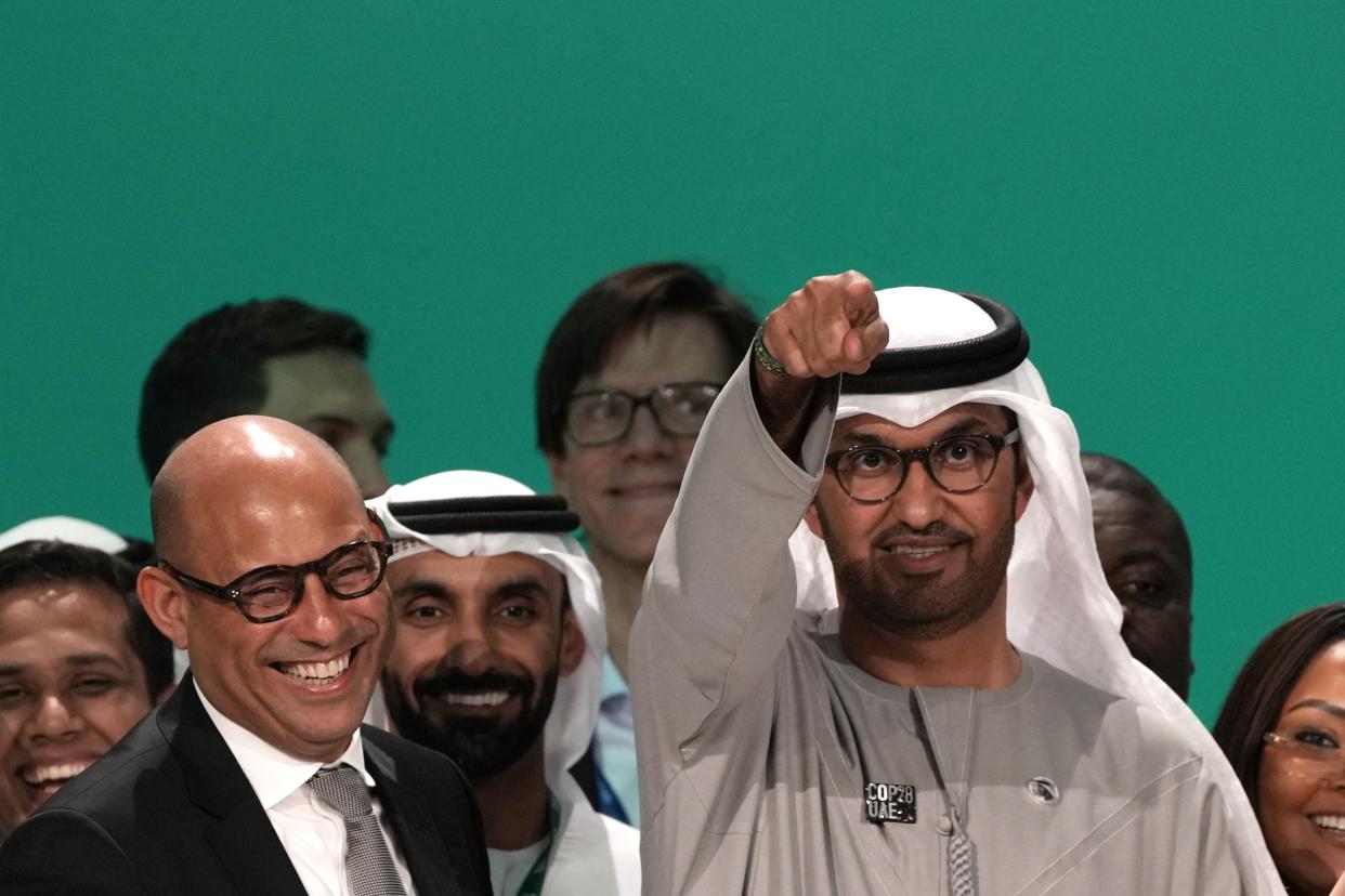 United Nations Climate Chief Simon Stiell, left, and COP28 President Sultan al-Jaber pose for photos at the end of the COP28 U.N. Climate Summit, Wednesday, Dec. 13, 2023, in Dubai, United Arab Emirates. (AP Photo/Kamran Jebreili)