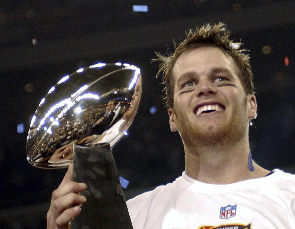FILE - In this Feb. 1, 2004, file photo, New England Patriots quarterback Tom Brady holds the Vince Lombardi Trophy after the Patriots beat the Carolina Panthers 32-29 in Super Bowl 38 in Houston. Brady, who won a record seven Super Bowls for New England and Tampa, has announced his retirement, Wednesday, Feb. 1, 2023. (AP Photo/Dave Martin, File)
