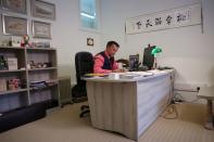 Head teacher Dr Gareth Lloyd works at his desk at Malvern St James Girls' School In Malvern, Britain