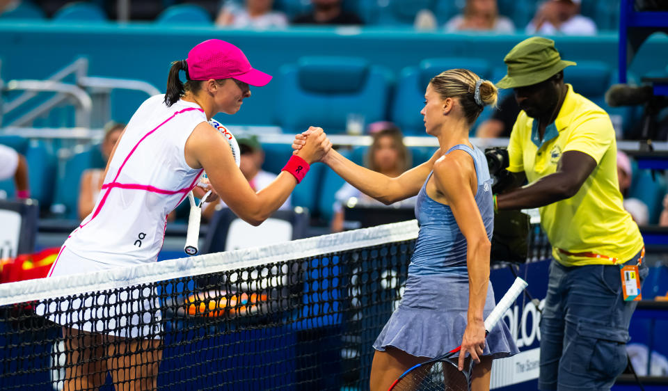 MIAMI GARDENS, FLORIDA - MARCH 23: Iga Swiatek of Poland and Camila Giorgi of Italy shake hands at the net after the second round on Day 8 of the Miami Open Presented by Itau at Hard Rock Stadium on March 23, 2024 in Miami Gardens, Florida (Photo by Robert Prange/Getty Images)