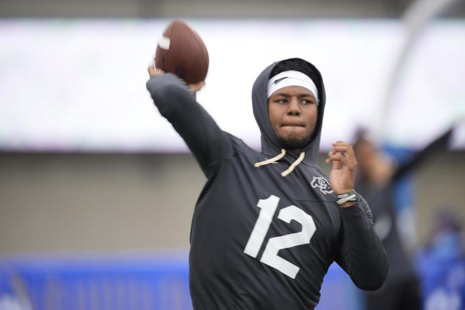 Colorado quarterback Brendon Lewis warms up before a game.