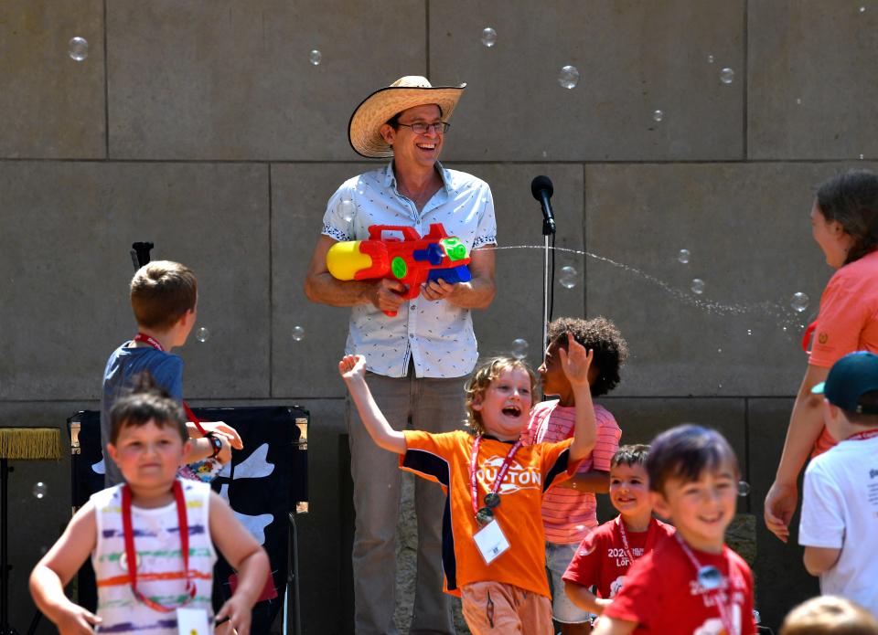 Musician Joe McDermott uses a squirt gun on his audience before his show last year.