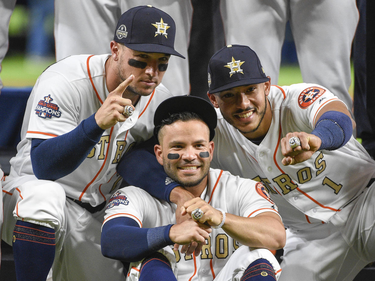 Houston Astros’ Alex Bregman, left, Jose Altuve, center, and Carlos Correa show their World Series rings before the team’s baseball game against the Baltimore Orioles, Tuesday, April 3, 2018, in Houston. (AP Photo/Eric Christian Smith)