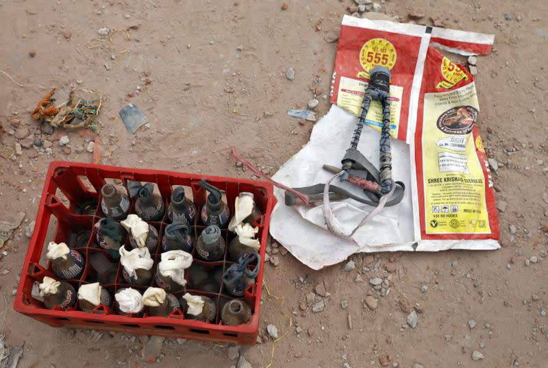 A slingshot and petrol bombs are pictured on the rooftop of a house in a riot affected area following clashes between people demonstrating for and against a new citizenship law in New Delhi