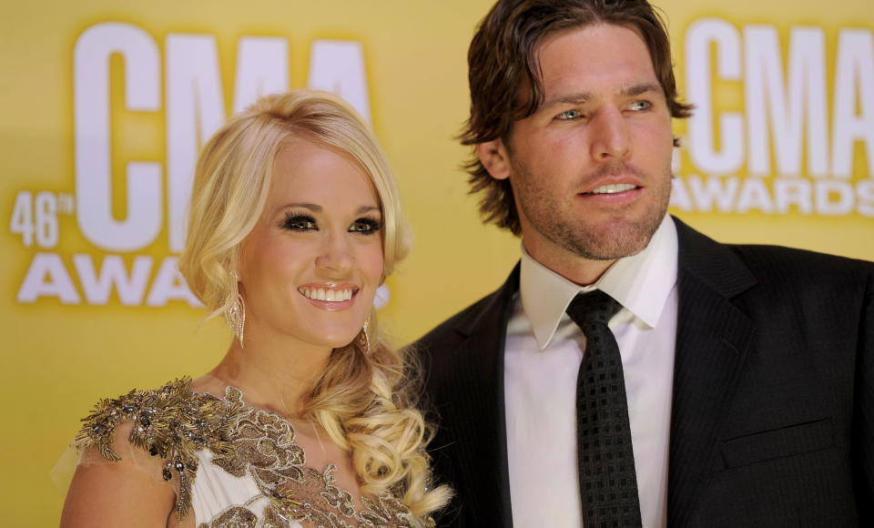 Carrie Underwood, left, and Mike Fisher arrive at the 46th Annual Country Music Awards at the Bridgestone Arena on Thursday, Nov. 1, 2012, in Nashville, Tenn. (Photo by Chris Pizzello/Invision/AP)