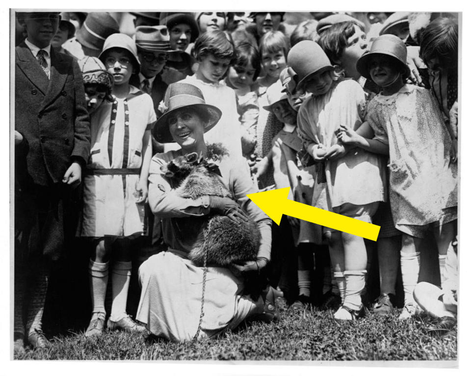 the first lady holding the pet while children stand behind her