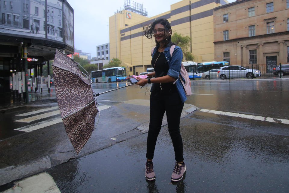 A pedestrian is seen during a storm in central Sydney last year. Source: AAP