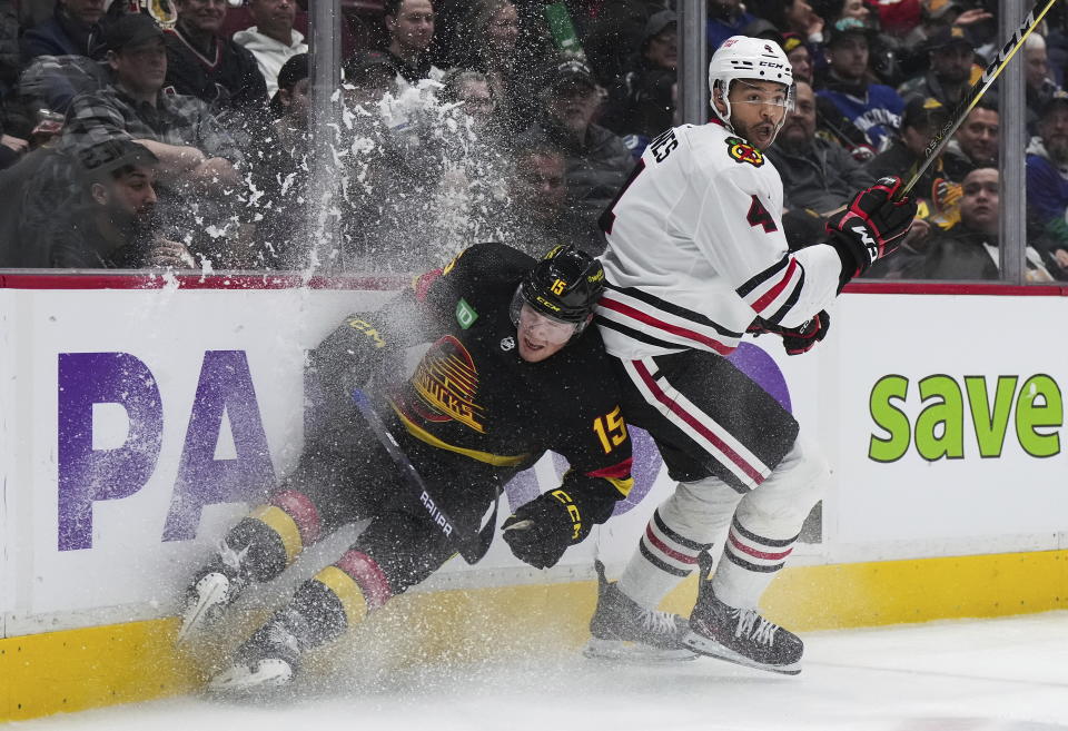 Vancouver Canucks' Sheldon Dries, left, and Chicago Blackhawks' Seth Jones collide during the third period of an NHL hockey game Tuesday, Jan. 24, 2023, in Vancouver, British Columbia. (Darryl Dyck/The Canadian Press via AP)