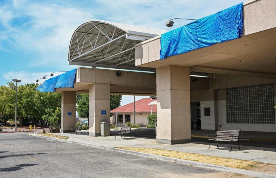 Tarps cover the signs outside Madera Community Hospital and the ER on Monday, July 24, 2023. The hospital closed early this year.