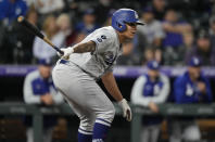 Los Angeles Dodgers' Julio Urias follows the flight of his RBI-single in the fifth inning of a baseball game Tuesday, Sept. 21, 2021, in Denver. (AP Photo/David Zalubowski)
