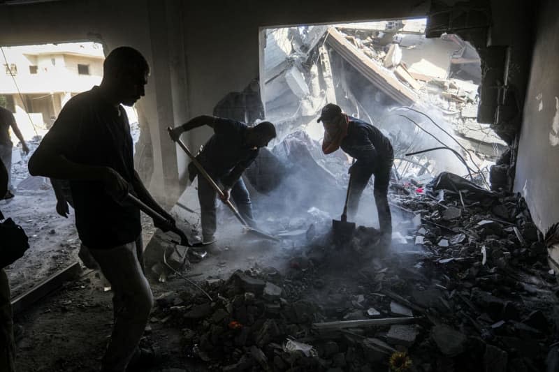 Palestinians inspect the damage to the house of Jamil Mazhar, deputy secretary-general of the Popular Front for the Liberation of Palestine, which was targeted in an overnight Israeli airstrike in the Nuseirat refugee camp. Abed Rahim Khatib/dpa