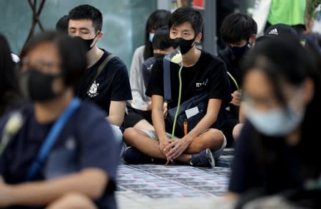 Anti-government protesters sit during a demonstration in Tiu Keng Leng in Hong Kong