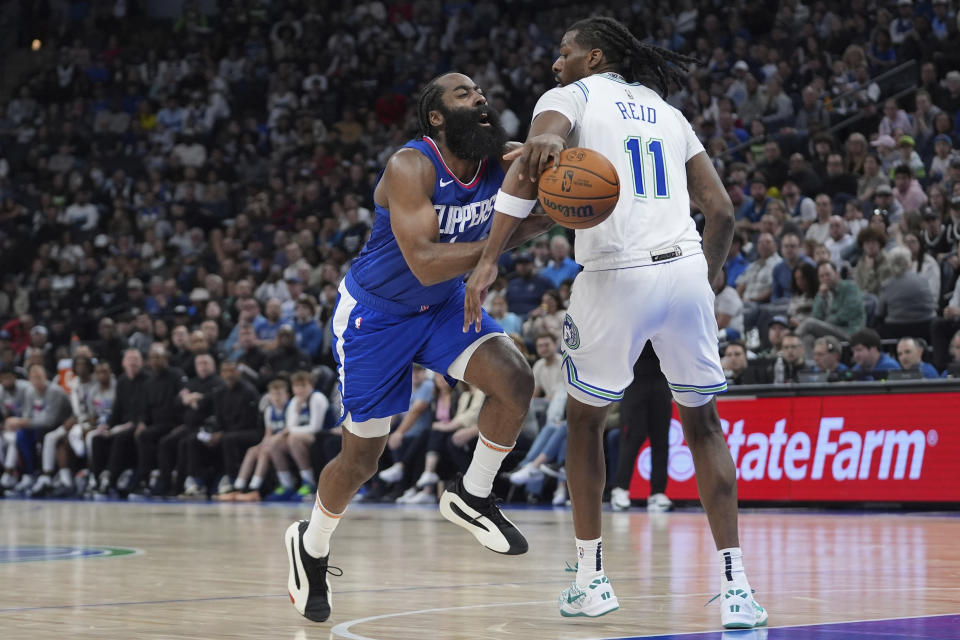 Los Angeles Clippers guard James Harden works toward the basket as Minnesota Timberwolves center Naz Reid (11) defends during the first half of an NBA basketball game, Sunday, March 3, 2024, in Minneapolis. (AP Photo/Abbie Parr)