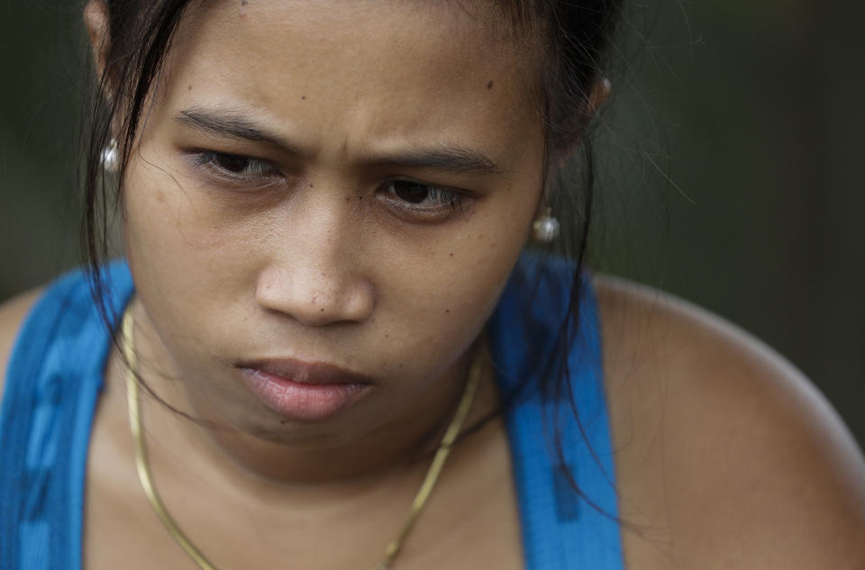 Trisha May Noche, mother of Kobe Christ Manjares, pauses during an interview with the Associated Press outside their house in Tanauan, Batangas province, Philippines, Wednesday, July 15, 2020. Her 16-day-old son Kobe was heralded as the country's youngest COVID-19 survivor. But the relief and joy proved didn't last. Three days later, Kobe died on June 4 from complications of Hirschsprung disease, a rare birth defect. (AP Photo/Aaron Favila)