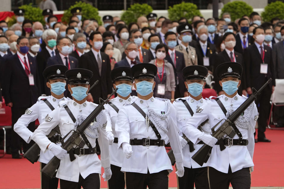 Guard of honour march to the flag raising ceremony at the Golden Bauhinia Square for the celebration of 24th anniversary of Hong Kong handover to China, in Hong Kong, Thursday, July 1, 2021. (AP Photo/Kin Cheung)