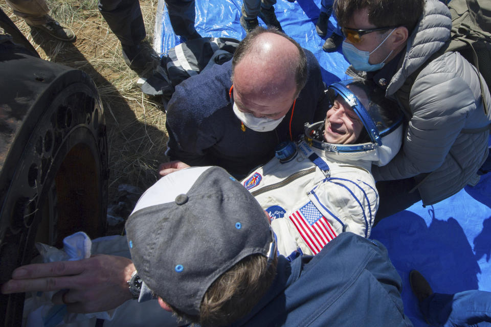 In this handout photo released by Gagarin Cosmonaut Training Centre (GCTC), Roscosmos space agency, rescue team members get out of the capsule U.S. astronaut Andrew Morgan shortly after the landing of the Russian Soyuz MS-15 space capsule near Kazakh town of Dzhezkazgan, Kazakhstan, Friday, April 17, 2020. An International Space Station crew has landed safely after more than 200 days in space. The Soyuz capsule carrying NASA astronauts Andrew Morgan, Jessica Meir and Russian space agency Roscosmos' Oleg Skripochka touched down on Friday on the steppes of Kazakhstan. (Andrey Shelepin, Gagarin Cosmonaut Training Centre (GCTC), Roscosmos space agency, via AP)