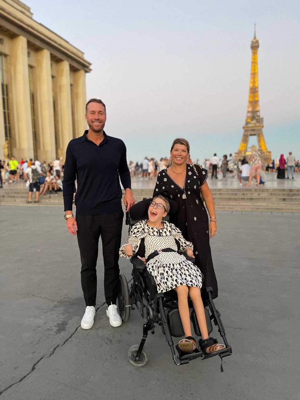 Richard Laver with his wife, Michelle, and daughter, Katie, who is seated in a wheelchair. The family is on vacation in Paris.