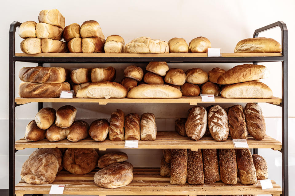 Bakery shelf lined with freshly-baked bread