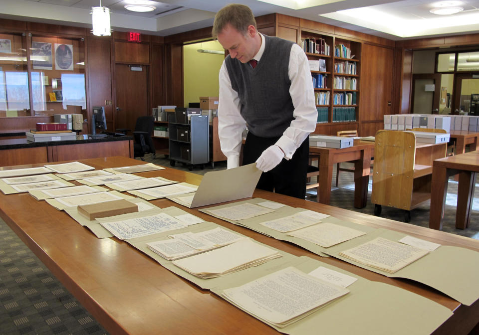 In this Nov. 27, 2012 photo Marquette University Archivist Bill Fliss arranges some of the 11,000 J.R.R. Tolkien papers the university owns in the library of the Milwaukee school _ home to the largest Tolkien collection in the world. Marquette offered it's first class on J.R.R. Tolkien during the fall semester as part of their anniversary celebration of the 75th anniveresary of the "The Hobbit" being published. When "The Hobbit" movie opens Friday, the 32 students in the class will be nearly experts on J.R.R. Tolkien. (AP Photo/Carrie Antlfinger)