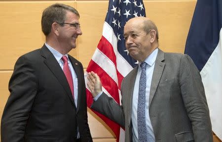 U.S. Secretary of Defense Ash Carter (L) speaks with French Defense Minister Jean-Yves Le Drian prior to a meeting in marge of a NATO defense ministers council at the Alliance's headquarters in Brussels, Belgium February 11, 2016. REUTERS/Virginia Mayo/Pool