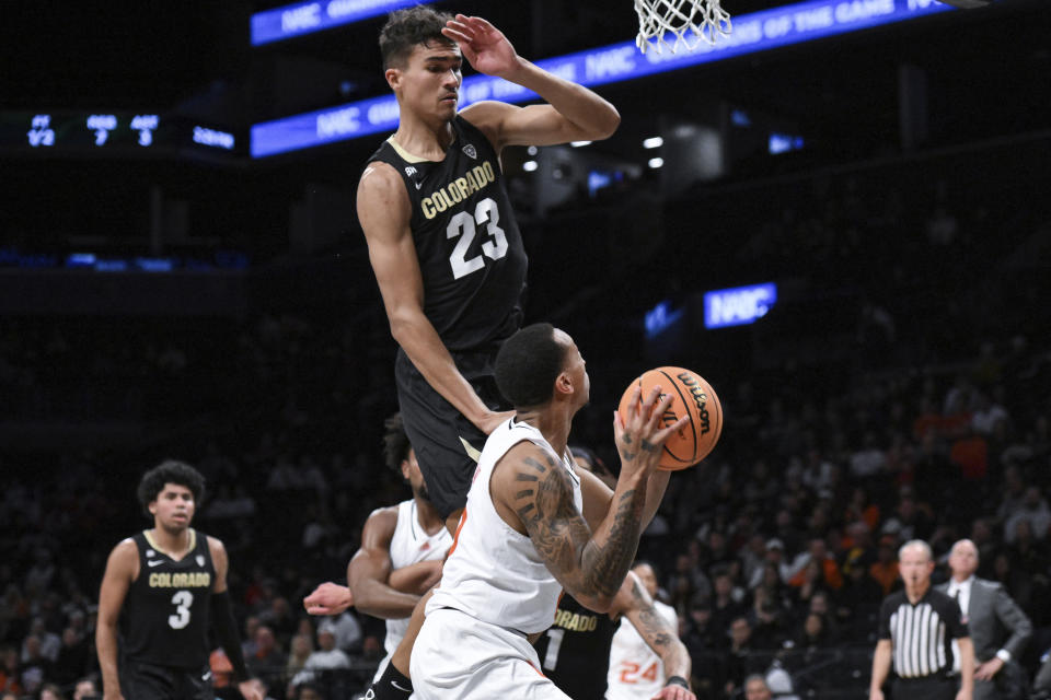 Miami guard Matthew Cleveland looks to shoot the ball while being defended by Colorado forward Tristan da Silva (23) during the first half of an NCAA college basketball game in the NABC Brooklyn Showcase, Sunday, Dec. 10, 2023, in New York. (AP Photo/John Jones)