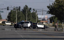 Police cars block off a street where a sheriff's deputy was shot while in his patrol car in Palmdale, Calif. on Sunday, Sept. 17, 2023. (AP Photo/Richard Vogel)