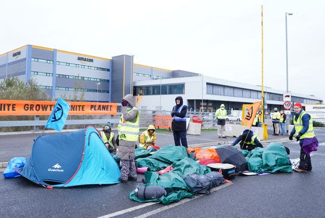 Activists block the entrance to the Amazon centre in Tilbury, Essex