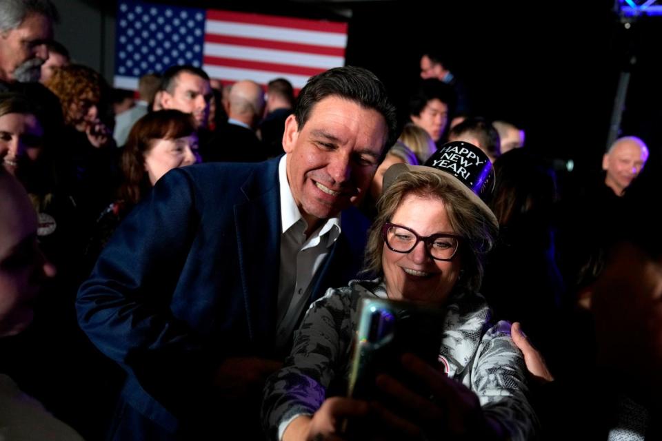 PHOTO: Republican presidential candidate Florida Gov. Ron DeSantis greets audience members during a New Year's Eve campaign event, Dec. 31, 2023, in West Des Moines, Iowa. (Charlie Neibergall/AP)