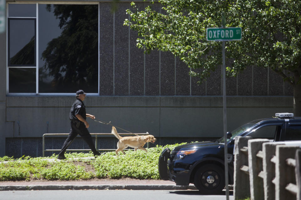 CAMBRIDGE, MA - JULY 5: Bomb smelling dogs are taken around the building as the Cambridge Police Department responds to a violent threat in the Science Building on Saturday afternoon, July 5, 2014. Police say the campus was threatened with an armed gunman and several bombs placed in the buildings. (Photo by Zack Wittman for The Boston Globe via Getty Images)