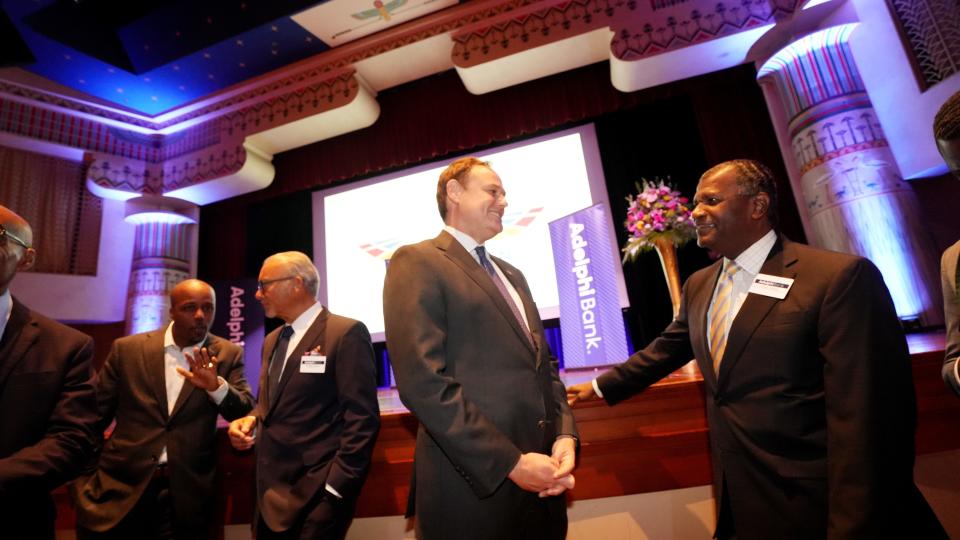 Adelphi Bank Executive Vice President & Chief Financial Officer Tommy Brooks  (right) and Tim Spence, CEO of 5/3 Bank, talk before the ribbon cutting of the new Adelphi Bank, which is currently the only Black-owned bank in Ohio. At far left is Sean Grant of the Columbus Partnership and former Columbus Mayor Michael Coleman.