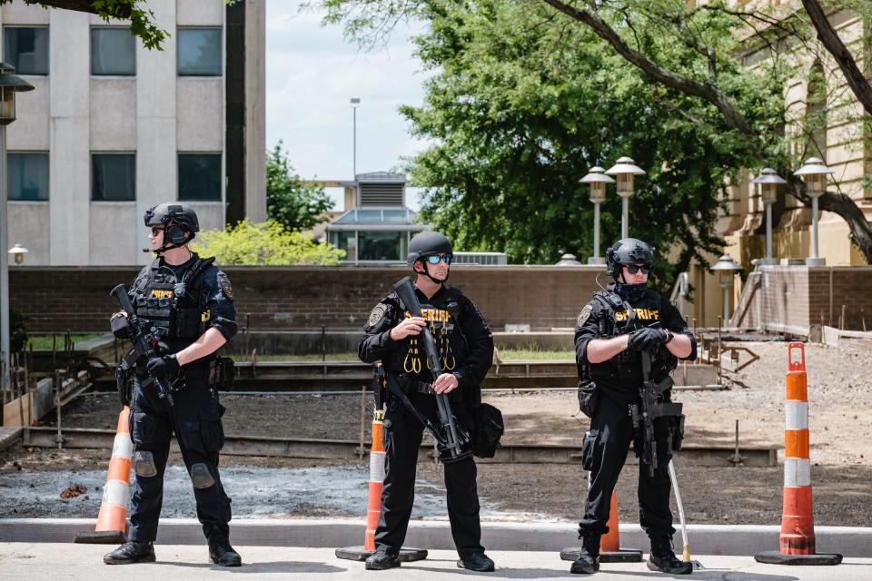 Summit County Sheriff's Office officers maintain a security perimeter Sunday during the Akron NAACP-led march for Jayland Walker downtown.