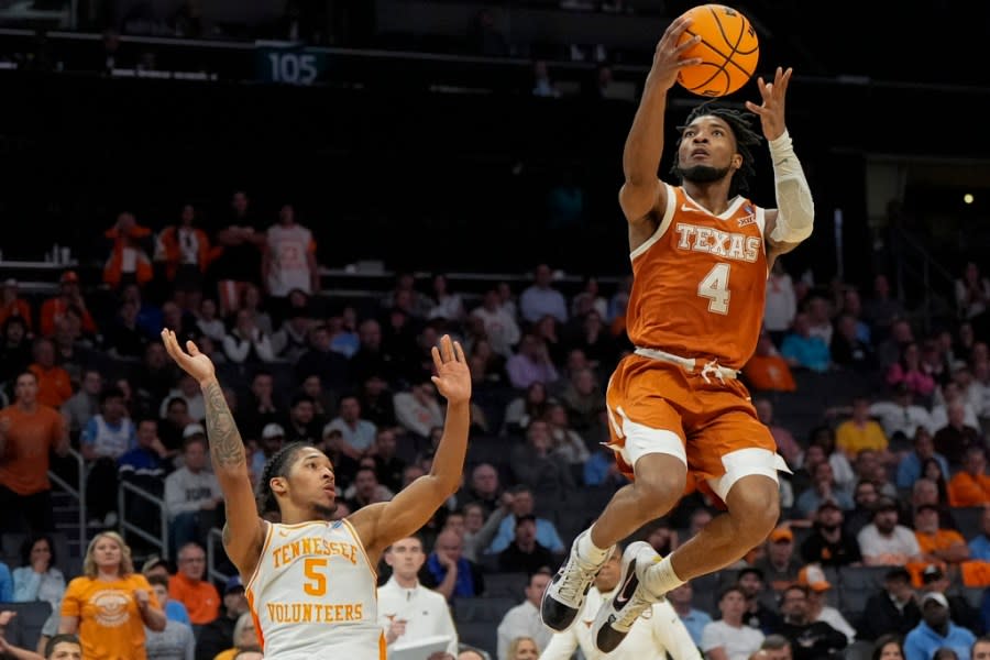 Texas guard <a class="link " href="https://sports.yahoo.com/ncaab/players/162547/" data-i13n="sec:content-canvas;subsec:anchor_text;elm:context_link" data-ylk="slk:Tyrese Hunter;sec:content-canvas;subsec:anchor_text;elm:context_link;itc:0">Tyrese Hunter</a> (4) goes to the hoop against <a class="link " href="https://sports.yahoo.com/ncaab/teams/tennessee/" data-i13n="sec:content-canvas;subsec:anchor_text;elm:context_link" data-ylk="slk:Tennessee;sec:content-canvas;subsec:anchor_text;elm:context_link;itc:0">Tennessee</a> guard <a class="link " href="https://sports.yahoo.com/ncaab/players/163583/" data-i13n="sec:content-canvas;subsec:anchor_text;elm:context_link" data-ylk="slk:Zakai Zeigler;sec:content-canvas;subsec:anchor_text;elm:context_link;itc:0">Zakai Zeigler</a> (5) during the second half of a second-round college basketball game in the NCAA Tournament, Saturday, March 23, 2024, in Charlotte, N.C. (AP Photo/Mike Stewart)