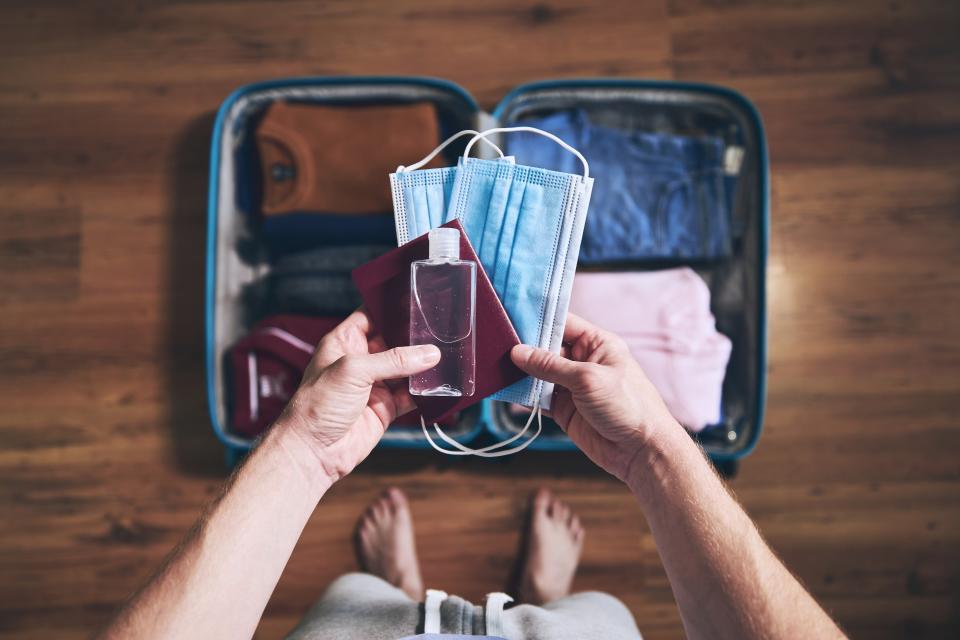 Travelers will likely include extra hand sanitizer, soap, face masks, and face shields when they travel in 2021. (Photo: Getty)