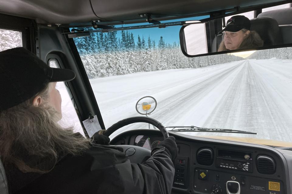 Trish Donahoe drives an electric school bus in Tok, Alaska. It works OK on the daily route, but because cold temperatures rob electric vehicle batteries of critical traveling range, No. 50 can't go on longer field trips, nor can it travel to Anchorage or Fairbanks if it needs repairs. It's the same problem that owners of electric passenger vehicles and transit officials are finding in cold climates worldwide.(AP Photo/Mark Thiessen)