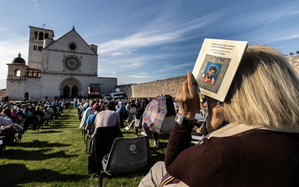 Faithful attend the beatification ceremony of Carlo Acutis at the St. Francis Basilica in Assisi, Italy