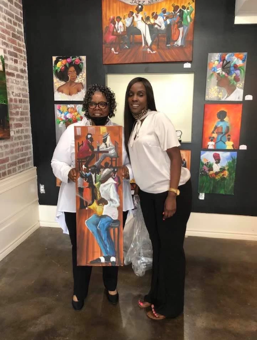 Theresa Cates and a customer at her grand opening of Majestic Motions Art Gallery in North Little Rock in August, 2021.