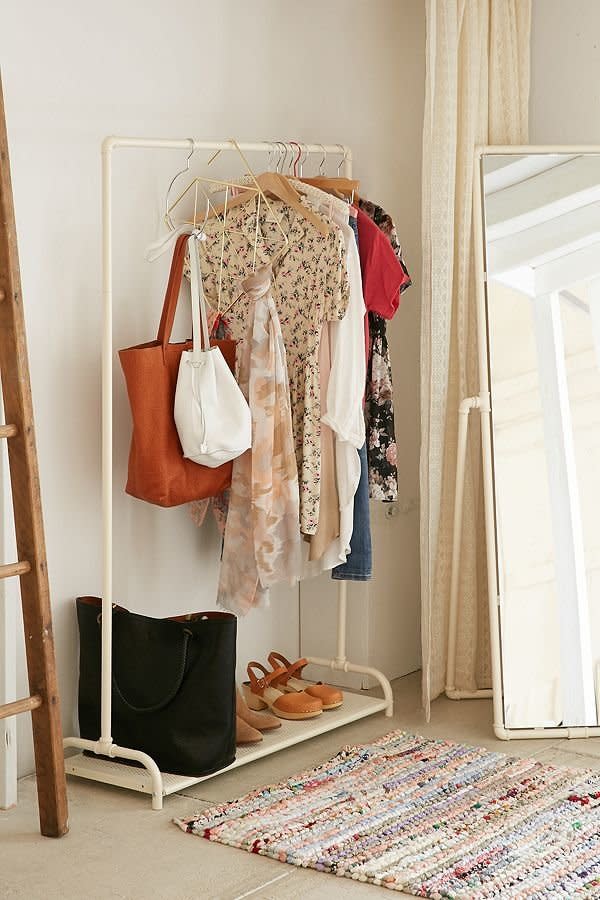 A clothing rack is an easy solution for adding more storage in tight spaces. <a href="https://www.urbanoutfitters.com/shop/pipe-clothing-rack?category=furniture&amp;color=010" target="_blank">These durable yet space-saving metal pipes</a> can hold your clothes and jackets while the bottom can store shoes, containers, bags, and more.