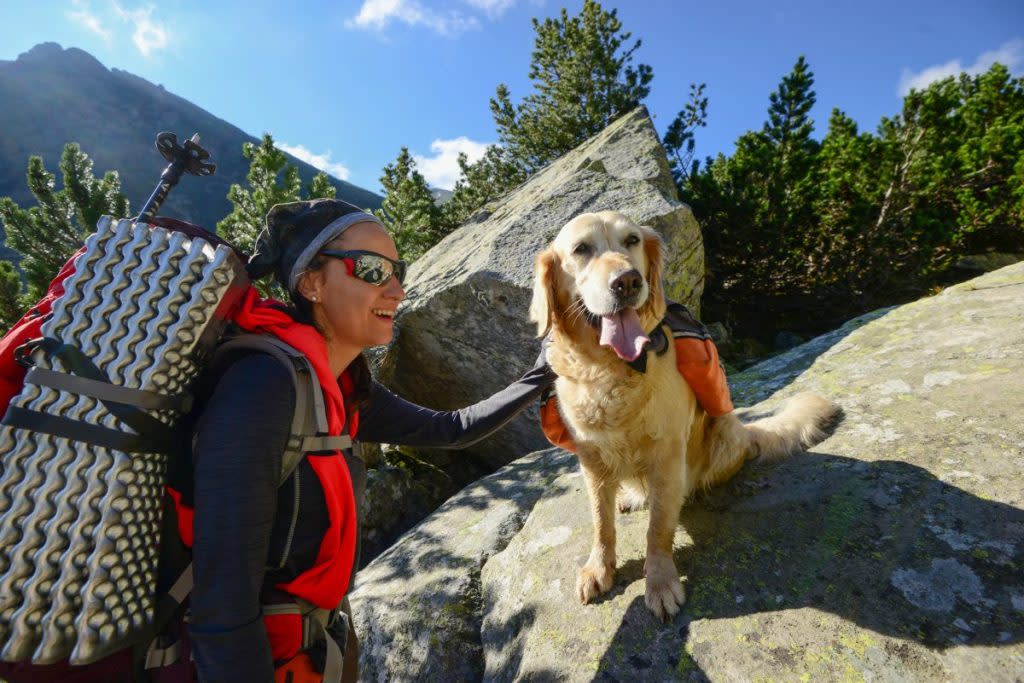 woman hiking with dog