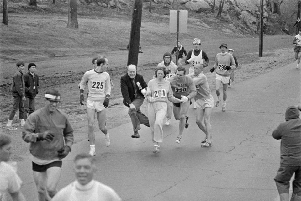 In the Boston Marathon, one of two women running in the normally all-male-race, Kathy Switzer, (261) of Syracuse, New York, is being hassled by BAA Marathon Director Bill Cloney, as he attempted to stop her from competing on April 19, 1967. The dark-haired girl did not show up for the physical examination required of all starters, (had she appeared at the starting line, she would never have been allowed to compete). she remained in the race, but was never seen near the finish line.